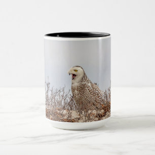 Snowy owl sitting on the beach mug