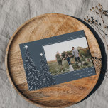 Snowy Pines | Elegant Christmas Photo Holiday Card<br><div class="desc">A modern and elegant Christmas holiday card design featuring a horizontal photo on a dark blue background adorned with pine trees laden with snow and topped with white stars. Personalise with your custom holiday greeting,  family name and the year.</div>