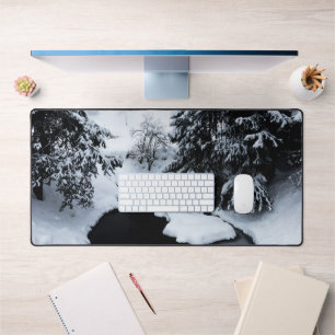 Snowy pond and trees disappearing in fog desk mat