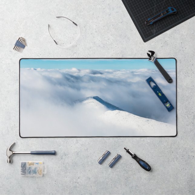 Snowy winter mountain wrapped in clouds desk mat (Workstation)