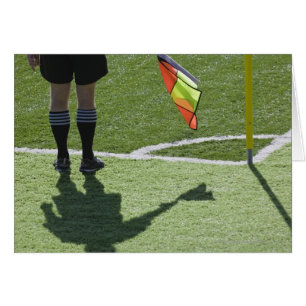 Soccer referee holding flag.