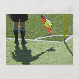 Soccer referee holding flag. postcard