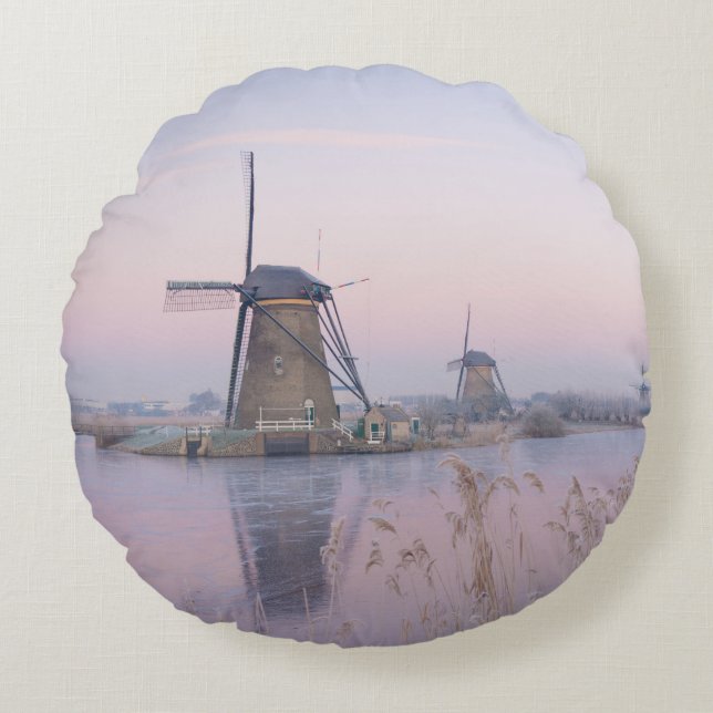 Soft sunrise light in winter over windmills round cushion (Front)