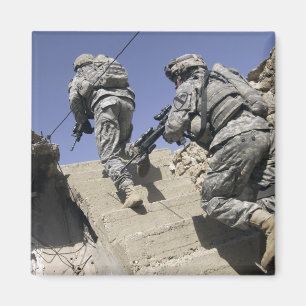 Soldiers running up staircase of a building magnet