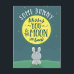 Some Bunny Misses You to the Moon and Back Postcard<br><div class="desc">Let someone know just how much they are missed with this cute,  illustrative card featuring the title,  "Some Bunny Misses You to the Moon and Back." Typography is centred in bright yellow moon on sky background with rabbit sitting on grass in foreground.</div>