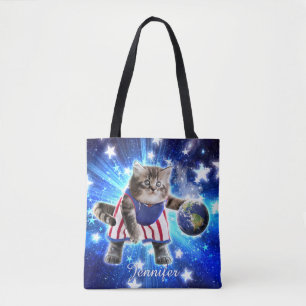 Space cat playing basketball tote bag