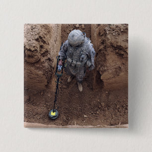 Specialist searches for a weapons cache 15 cm square badge
