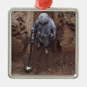 Specialist searches for a weapons cache metal tree decoration