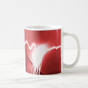 Sprayed graffiti on red metal coffee mug