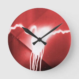 Sprayed graffiti on red metal round clock