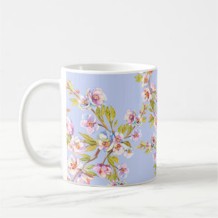 Sprigs of flowering apple or cherry trees on the b coffee mug
