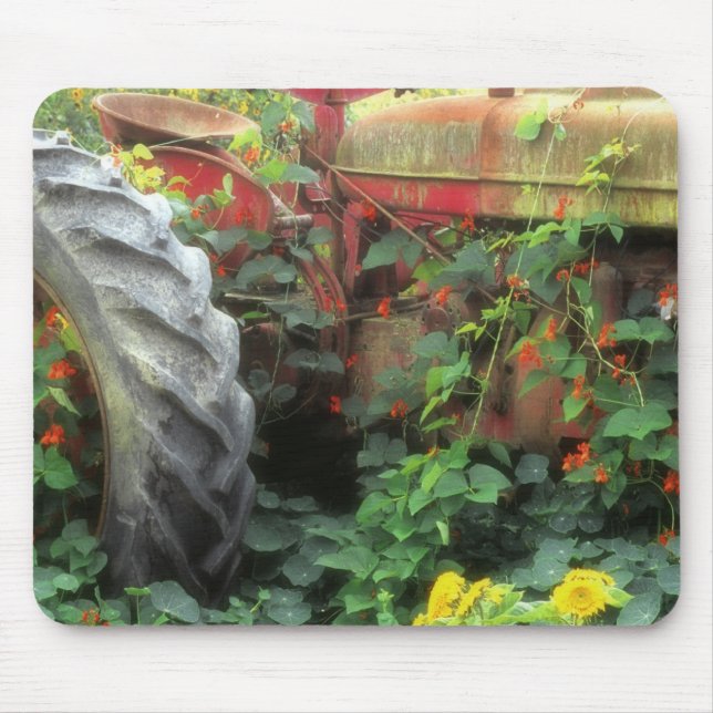 Spring flowers adorn an old tractor. mouse pad (Front)