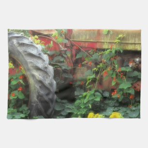 Spring flowers adorn an old tractor. tea towel