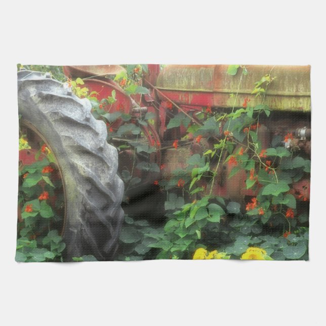 Spring flowers adorn an old tractor. tea towel (Horizontal)