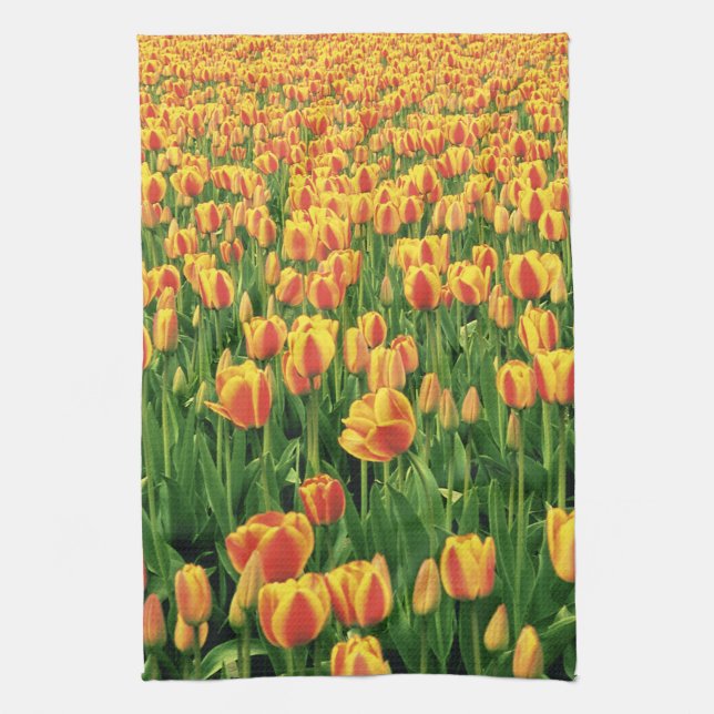 Spring tulips bloom in front of old barn. tea towel (Vertical)