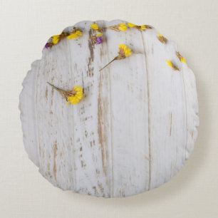 Spring yellow flowers, white plank decor. round cushion