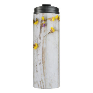 Spring yellow flowers, white plank decor. thermal tumbler