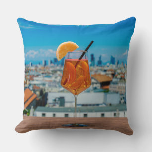 Spritz cocktail on a table with view of Milan Cushion