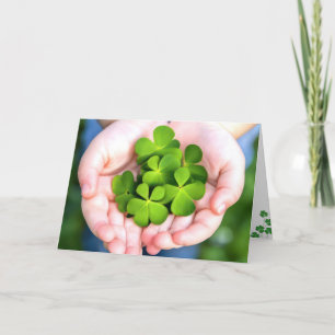 St. Patrick's Day Four-Leaf Clovers In Hand Holiday Card