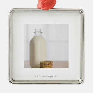 Stack of chocolate chip cookies milk in a glass metal tree decoration