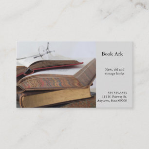 Stack of vintage books with glasses business card