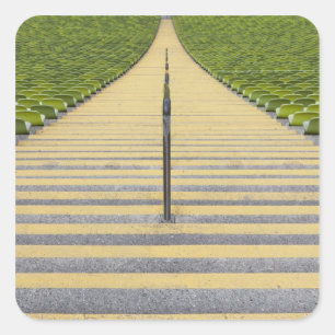 Stadium stairway between rows of green seats square sticker