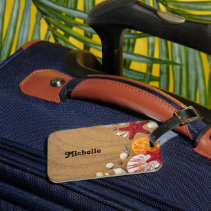 Starfish and seashells on brown beach sand luggage tag