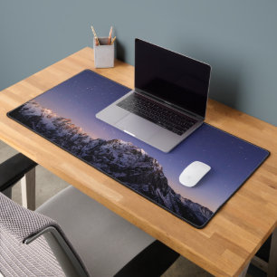 Starry sky above mountains desk mat