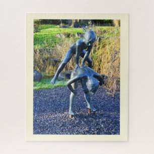 Statue of two children playing jigsaw puzzle