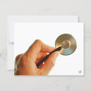 Stethoscope in a hand for a hospital atmosphere. postcard