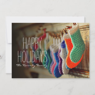 Stockings hanging along mantle holiday card