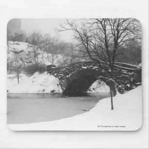 Stone bridge over snow covered river mouse pad