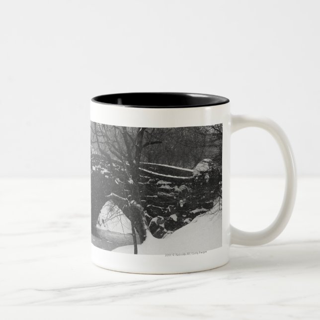 Stone bridge over snow covered river Two-Tone coffee mug (Right)