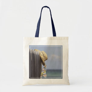 Straw Hat Hanging On Fence At Beach Tote Bag