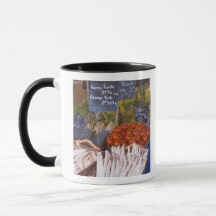 Street market merchant's stall with white mug