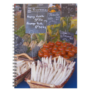 Street market merchant's stall with white notebook