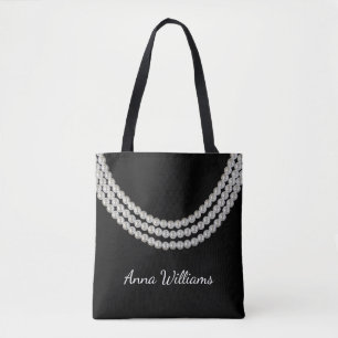 string of white pearls on black tote bag