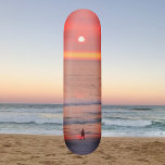 Strolling Through Golden Orange Sunset Skateboard<br><div class="desc">This skateboard features an image of a person walking through the golden pink and orange rays of the sunset. The colorful rays create an orb that silhouettes the walker.</div>