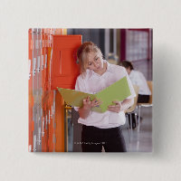Student removing binder from school locker