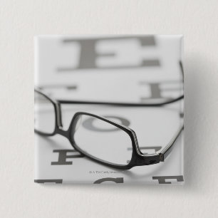 Studio shot of eyeglasses on eye chart 15 cm square badge