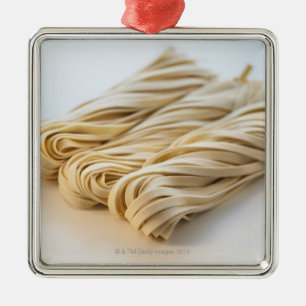 Studio shot of fresh linguini pasta metal ornament