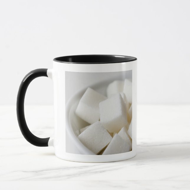 Studio shot of sugar cubes in bowl mug (Left)