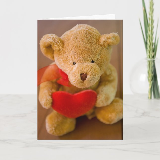 Stuffed teddy bear holding a heart greeting card (Front)