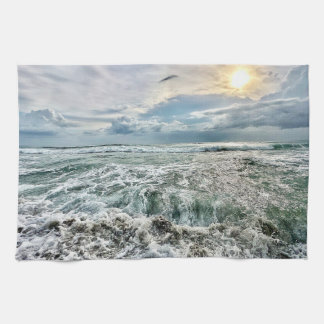 stunning beach scene with crashing waves tea towel
