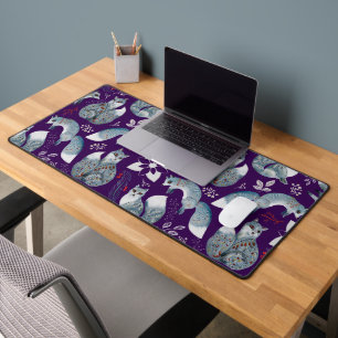 Stylised blue foxes with intricate floral designs Desk Mat