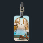 Stylized Teal Mediterranean Coastal Town Archway Luggage Tag<br><div class="desc">Spot your bags instantly at the airport carousel with this beautifully vibrant and artistic travel accessory. This high-quality luggage tag showcases a stunning, stylized retro illustration of a sun-drenched European coastal town, complete with a classic red scooter resting beneath an elegant stone archway. The bold flat vector aesthetic and rich...</div>