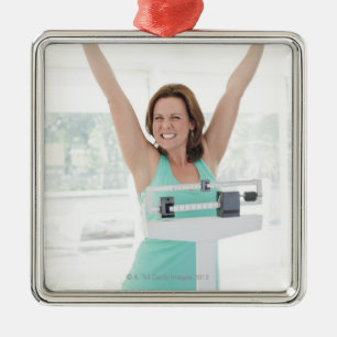 Successful weight loss. Happy woman weighing Metal Ornament