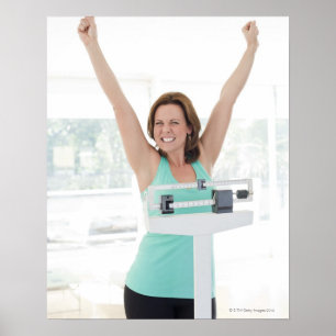 Successful weight loss. Happy woman weighing Poster