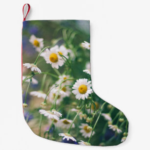 Summer flower pattern in green meadow with blue an small christmas stocking