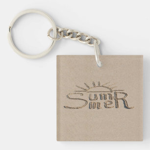 Summer sign carved on the beach sand key ring